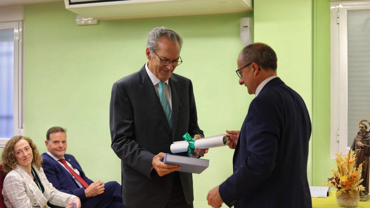 Rafael Sánchez Olea recoge el reconocimiento de manos de José Manuel Alonso, vicepresidente del Colegio de Veterinarios