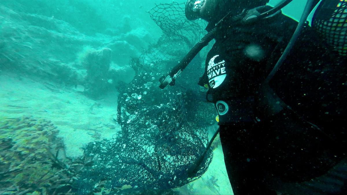Un buzo de Gravity Wave retirando redes de pesca del mar