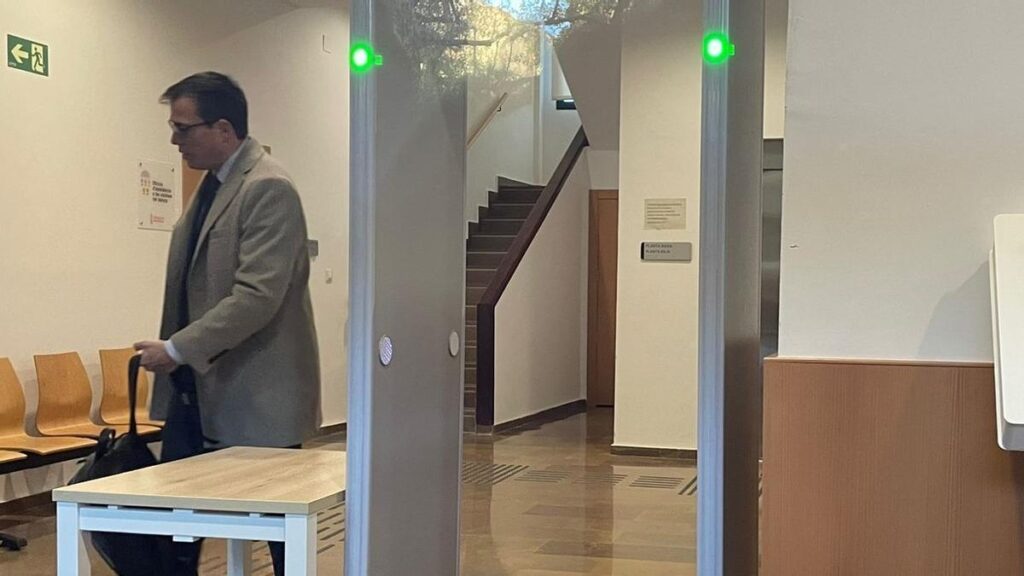 Cayetano García Ramírez, actual secretario autonómico de Economía, pasa el control de seguridad de los juzgados de Catarroja.